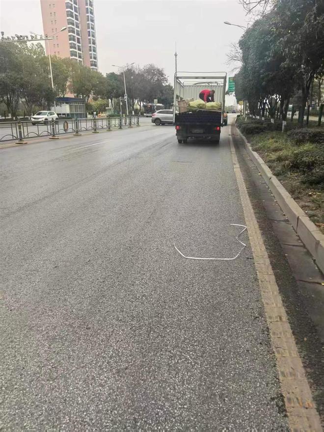 货车过红绿灯时甩下数根PE管蔡甸城管队员客串搬运工10余钟装车清障(图3)